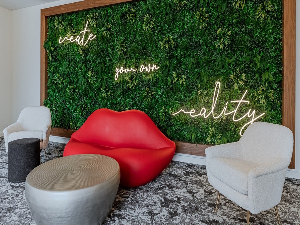 a living room with a red chair and a green wall
